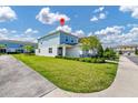 A well-maintained two-story house with lush green lawn and community setting at 743 Driving Range Ct, Reunion, FL 34747