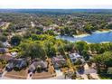 Aerial view of the property showcasing its proximity to a serene lake and lush green surroundings at 9681 Lake Douglas Pl, Orlando, FL 32817