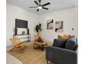 Cozy living room featuring neutral tones, comfortable seating, and a minimalist entertainment center at 9919 Cypress Park Dr, Orlando, FL 32824