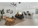 Bright, open-concept living room with modern furnishings, stylish decor, and seamless flow to the kitchen at 9919 Cypress Park Dr, Orlando, FL 32824