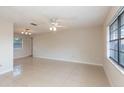 Open-concept living room with tile flooring, fan and natural lighting at 1030 Blue Horizon Dr, Deltona, FL 32725