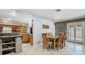Inviting dining room featuring tile flooring, natural lighting, and seamless flow to kitchen and pool at 105 Elizabeth Ave, Altamonte Springs, FL 32701