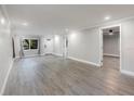 A spacious living room has hardwood floors and a calming neutral palette at 120 East St, Altamonte Springs, FL 32701