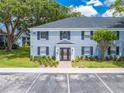Attractive two-story building with blue brick and black shutters surrounded by lush greenery at 130 Lewfield Cir # 130, Winter Park, FL 32792