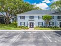 Well-maintained blue brick building with neat landscaping, black shutters, and convenient parking at 130 Lewfield Cir # 130, Winter Park, FL 32792