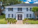 Charming two-story building with a brick facade, black shutters, and manicured landscaping at 130 Lewfield Cir # 130, Winter Park, FL 32792