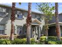 Inviting two-story home boasts a blue door, lush landscaping, and curb appeal at 14743 Driftwater Dr, Winter Garden, FL 34787