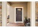 Charming entryway with stone accents and a comfortable bench for guests at 1801 Nice Ct, Kissimmee, FL 34747