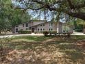 Attractive home featuring a manicured front yard, stone details, and a welcoming entrance at 202 Sweetwater Club Blvd, Longwood, FL 32779
