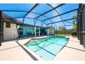 Inviting screened-in pool with an attached outdoor kitchen and ample seating for entertaining at 208 Madeira Ave, Orlando, FL 32825