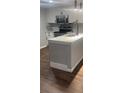 Modern kitchen with white cabinets, stainless steel appliances, and granite countertops at 2301 Oak Park Way # 101, Orlando, FL 32822