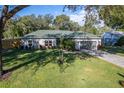 Charming single-story home with a gray exterior, a well-manicured lawn, and a paved driveway leading to a two-car garage at 2314 Pennsylvania Ave, Oviedo, FL 32765