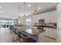 Modern kitchen with granite countertops, stainless steel appliances, and breakfast bar seating at 2515 W End Dr, St Cloud, FL 34772