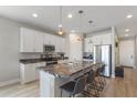 Bright kitchen with white cabinetry, granite counters, and stainless steel appliances at 2515 W End Dr, St Cloud, FL 34772