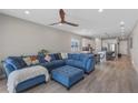 Comfortable open-plan living room with a large blue sectional sofa and stylish decor at 2515 W End Dr, St Cloud, FL 34772