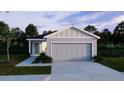 Beautiful single Gathering home with a well-manicured lawn and an attached two-car garage at 3884 Bluethread Way, Poinciana, FL 34759