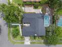 Aerial view of the property featuring a fenced pool, lovely roof, and attractive landscaping at 4118 Teriwood Ave, Orlando, FL 32812