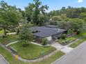 Aerial shot showcasing the home's layout, fenced yard, mature trees, and convenient driveway at 4118 Teriwood Ave, Orlando, FL 32812