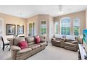 Bright living room with large windows, neutral tones, comfortable seating, and adjoining dining area at 422 Terrace Ridge Cir # 422, Davenport, FL 33896