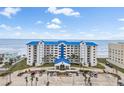 Coastal condo building with a blue roof, showcasing beach access and convenient parking at 4601 S Atlantic Ave # 7030, Port Orange, FL 32127