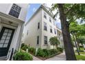 Side view of a well-maintained townhome with manicured landscaping and large windows for ample natural light at 4725 Anson Ln, Orlando, FL 32814