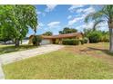 Charming single-story home featuring a two-car garage, mature landscaping, and a well-maintained lawn at 5001 Tangerine Ave, Winter Park, FL 32792