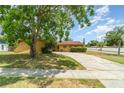 Charming single-story home with a well-maintained lawn and long driveway at 5001 Tangerine Ave, Winter Park, FL 32792