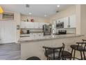 Bright kitchen with white cabinets, granite countertops, stainless steel appliances, and an island with breakfast bar at 502 Freeman St, Longwood, FL 32750