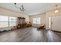 Spacious living room with laminate floors, large windows, and neutral paint at 502 Freeman St, Longwood, FL 32750