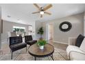 Inviting living room featuring stylish furniture, a ceiling fan, and seamless transition to the dining area at 507 Peach Tree Ln, Altamonte Springs, FL 32701