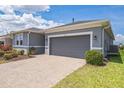View of a home's garage and driveway, highlighting the well-maintained exterior at 525 Narrow View Ln, Groveland, FL 34736