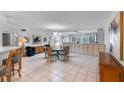 A bright dining area featuring tile floors, a chandelier, and a table with seating for six at 6330 Masters Blvd # N4, Orlando, FL 32819