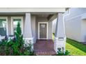 Inviting front entrance with brick pavers, decorative columns, and a covered porch area with seating at 635 Cheval Ln, Debary, FL 32713