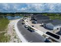 New homes are being built near a tranquil pond, creating a picturesque community setting at 6717 Yellow Warbler Bnd, St Cloud, FL 34771