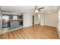 View of the open floor plan showing the kitchen with blue cabinets, stainless steel appliances, and a breakfast bar at 845 N Ludlum Dr, Deltona, FL 32725