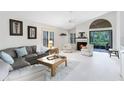 Bright living room features a cozy fireplace, plush seating, and sliding doors to the patio at 912 Augusta National Blvd, Winter Springs, FL 32708