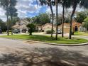 Neighborhood street featuring houses with well-manicured lawns and mature palm trees at 912 Augusta National Blvd, Winter Springs, FL 32708