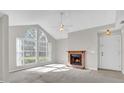 Bright and airy living room with a charming brick fireplace and large arched windows allowing natural light at 948 Bird Bay Ct # 102, Lake Mary, FL 32746