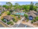 A luxurious community pool featuring lounge chairs, a hot tub, and beautiful green landscaping around the area at 948 Bird Bay Ct # 102, Lake Mary, FL 32746