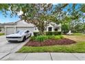 Charming single-story home with a well-maintained front yard and a two-car garage at 955 Holly Springs Ter, Oviedo, FL 32765