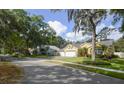 Inviting single-story home with a three-car garage, mature trees, and charming curb appeal at 1006 Hanging Vine Pt, Longwood, FL 32750