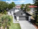 Beautiful single-story home with a grey roof, two-car garage and well-maintained lawn at 181 Pinewood Cir, Kissimmee, FL 34743