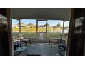 Serene screened patio with seating and picturesque views of the pond and beautifully landscaped backyard at 2244 Silver Lakes N Dr, Lakeland, FL 33810