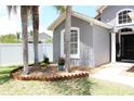 Landscaped front yard with a mulch bed, plants, and green grass at 2407 Oakington St, Winter Garden, FL 34787