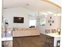 Open-concept living room featuring luxury vinyl plank flooring and vaulted ceilings at 2407 Oakington St, Winter Garden, FL 34787