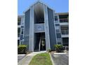 Exterior view of a blue and gray two-story building with an open stairwell to upper units at 2516 Grassy Point Dr # 210, Lake Mary, FL 32746