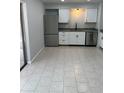 Bright kitchen featuring stainless steel appliances and neutral toned tile flooring at 261 Deleon Rd, Debary, FL 32713