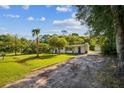 Charming one-story home with a lush green lawn, accented by mature trees at 2647 S Myrtle Ave, Sanford, FL 32773
