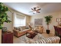 Comfortable living room offers stylish furnishings, fan, decor, natural light, and open floor plan at 2919 Banana Palm Dr, Kissimmee, FL 34747