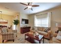 Living room includes sofa, club chair, television, natural light, and decor at 2919 Banana Palm Dr, Kissimmee, FL 34747